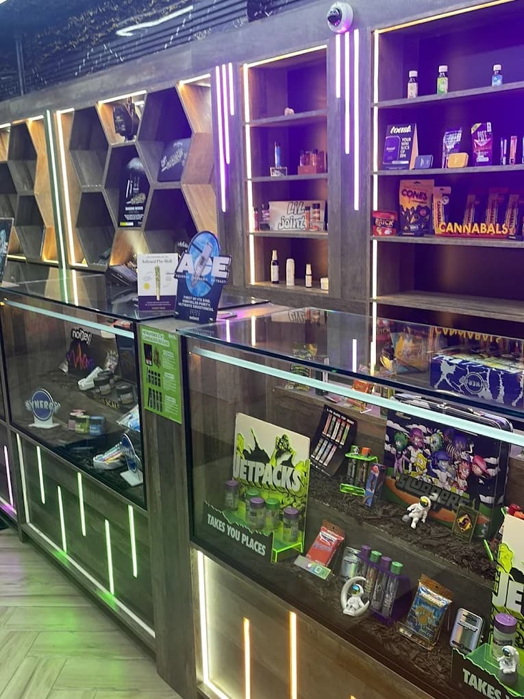 Neon-lit hexagon shelving and glass cases at Rezidue
